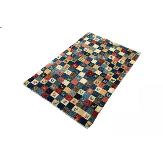 This colorful Gabbeh Nomad rug is an expressive example of traditional craftsmanship with modern charm. The design...