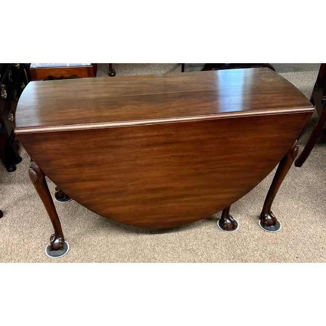 I believe from the research I've done that this is a rare Gateleg table made by Kittinger CW74 for Colonial Williamsburg....