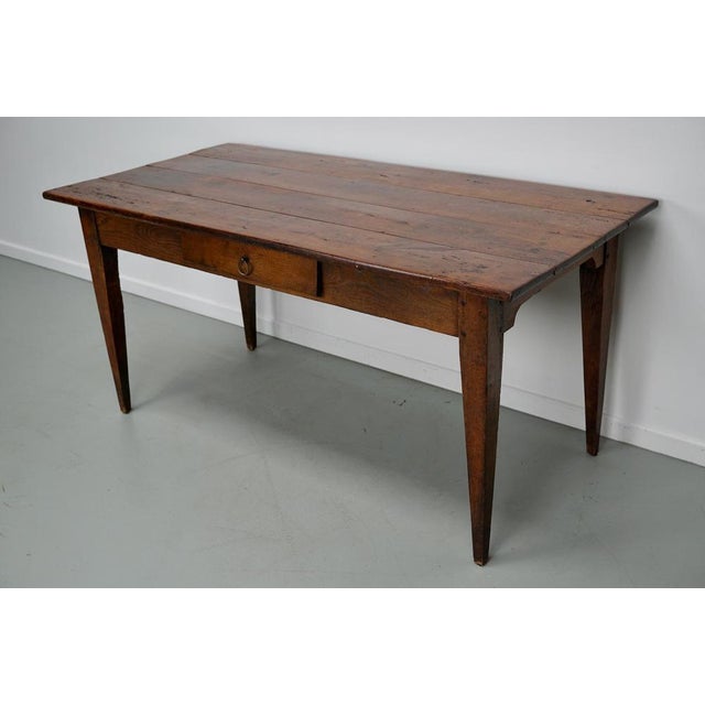 This elegant table was made in Southern France in the mid 19th century. The table was made in solid fruitwood with...