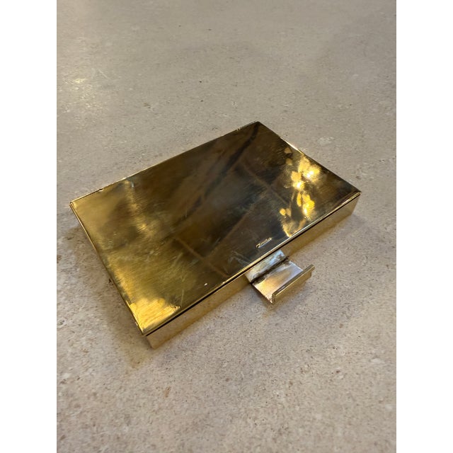 A refined mid-century Italian brass gentleman’s travel case, designed with a clean rectangular silhouette and warm...