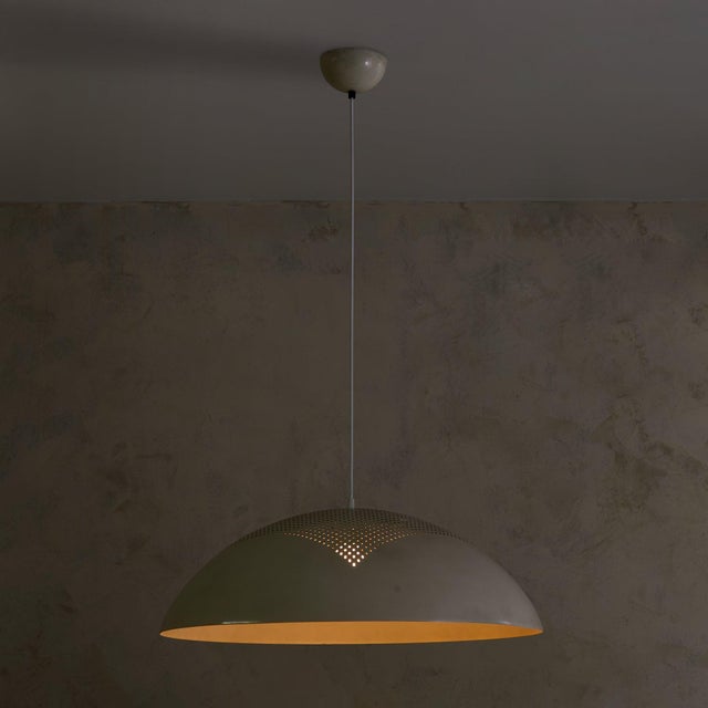 This 1970s pendant, attributed to Pruluce Vicenza, distills industrial design into a form of poetic simplicity. The wide...