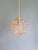 Trio of amber-colored bubble glass and brass pendant lights, designed by helena tynell for the german manufacturer...