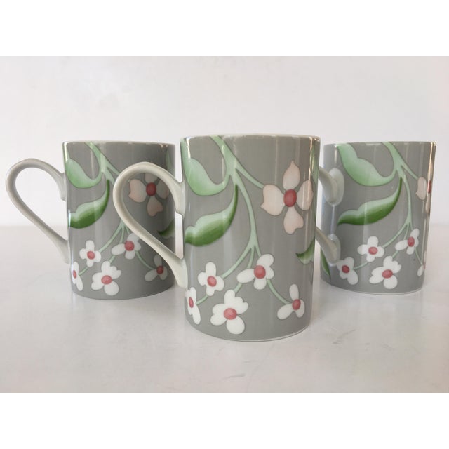 Offering a beautiful set of three porcelain mugs by Fitz And Floyd in the pattern "Chanson des Fleurs". These vintage mugs...