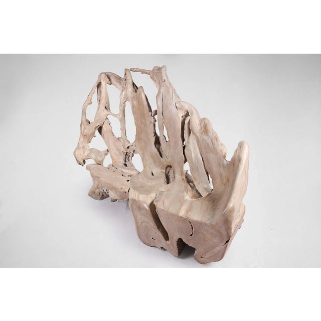 The beautiful natural shape of the teak root is captured in this teak root bench. This modern organic teak root bench is...