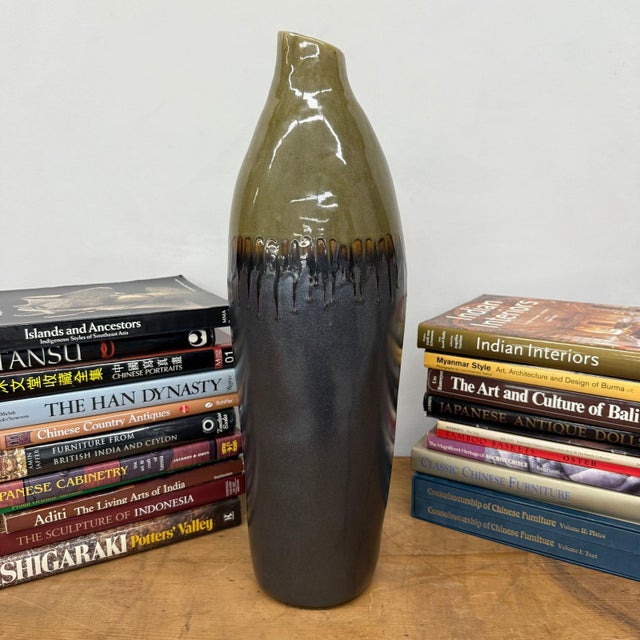 "About This Piece About This Piece This tall ceramic vase carries the presence of a sculptural statement piece, with a...