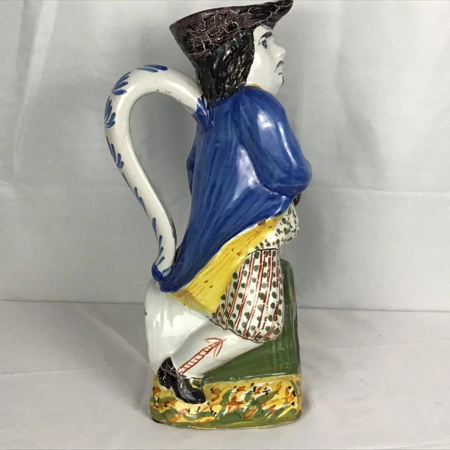 19th Century Antique Ceramic Toby Jug, Colonial Man Sitting on Keg. Wonderful bright colors of yellow, blue, and green....