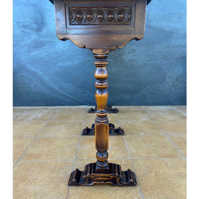 Elegant Spanish console table designed by Valenti, crafted in finely carved wood. The piece features a long rectangular...