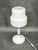 A distinctive 1970s table lamp by drukov, czechoslovakia, characterized by its sculptural geometric form and elegant...