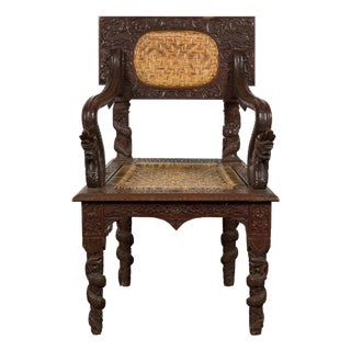 Anglo-Indian 1900 Armchair with Carved Back, Mythical Creatures and Woven Rattan For Sale