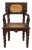 Anglo-Indian 1900 Armchair with Carved Back, Mythical Creatures and Woven Rattan For Sale