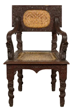 Anglo-Indian 1900 Armchair with Carved Back, Mythical Creatures and Woven Rattan