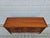 This Baker Furniture cherry wood sideboard or credenza features a banded and inlayed top and cabinet doors with a diamond...
