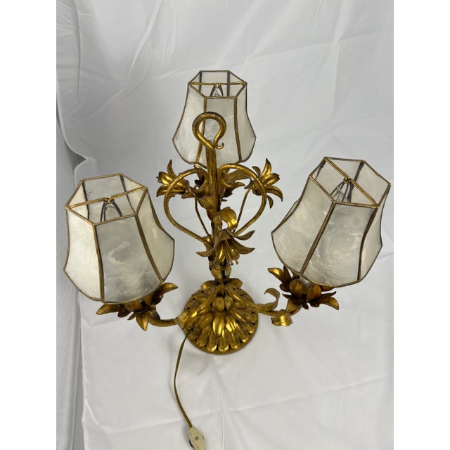 Italian gilt metal and lamp with capiz shell lamp shades. This lamp is in very good condition. This unique piece really...