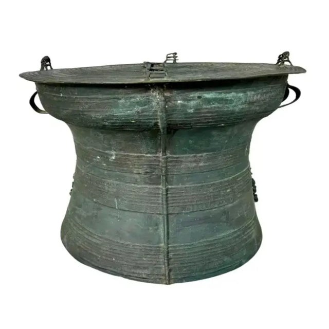 Hollow bronze drum, tapering downwards, with handles on each side. Drums were made by the Karen people--A Sino-Tibetan...