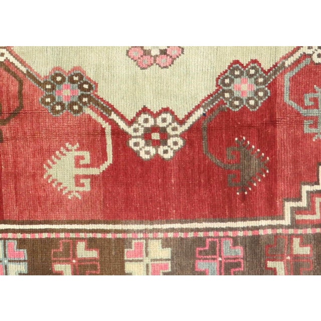 Handwoven wool-on-wool Oushak rug from vintage Turkey, measuring 4'8" x 9'5". Originating from the storied weaving...