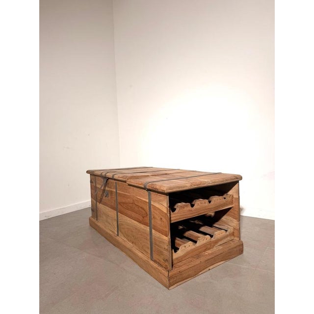 A distinctive storage chest crafted from solid teak, combining generous storage space with an integrated wine rack. The...