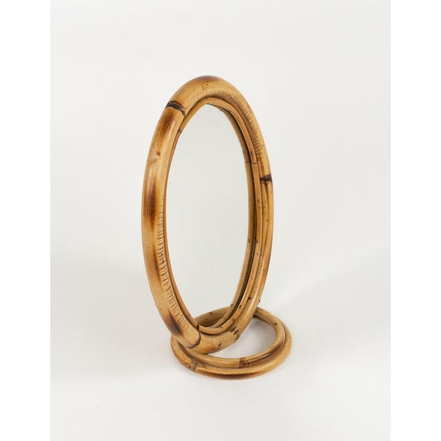 Midcentury beautiful oval vanity table mirror in bamboo and rattan. Made in Italy in the 1970s.