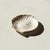 A vintage capiz shell tray in the shape of a seashell with brass edging. Lovely variation to the natural semi iridescent...