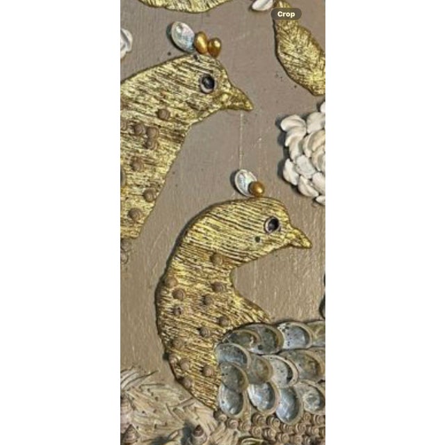 A pair of birds nestled in fantasy foliage executed in shells and gold leafed elements. The circumference is bound by a...