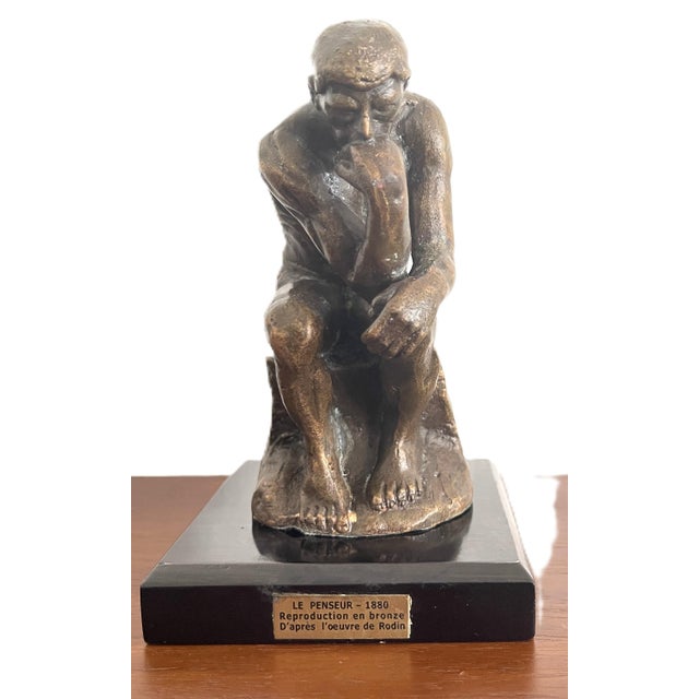 This bronze reproduction of Rodin’s *The Thinker* is one of the most iconic works in the history of modern sculpture. A...