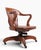 Classic antique swivel, tilt, Bank of England, Jury style desk chair. The chair features a continuous arm, back rest,...