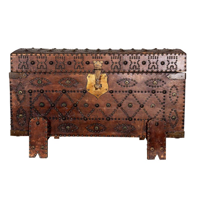 Leather traveling trunk with intricate hobnail patterned studs and red interior. Original brass hardware and front clasp....