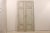 A pair of tall French doors from the mid-19th century. These French doors feature a grey green finish with wood coming...