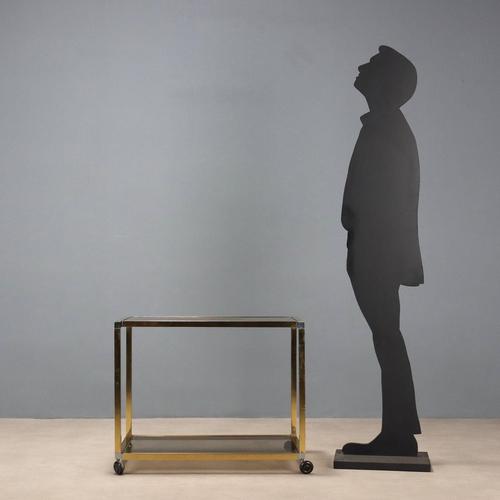Trolley with double shelf, brass and smoked glass. This piece is attributed to the mentioned designer/maker. It has no...