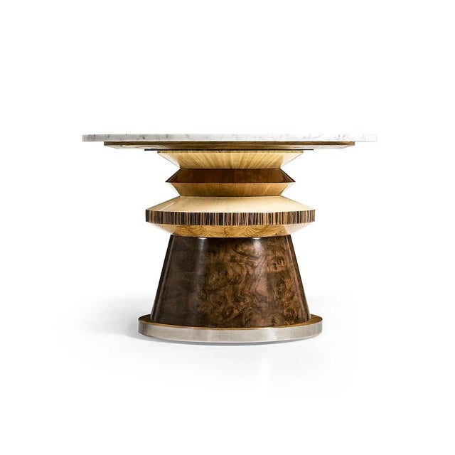 Crafted from an array of layered veneers - walnut burl, cerajeira, ebony, maple, chestnut, and eucalyptus—this table...