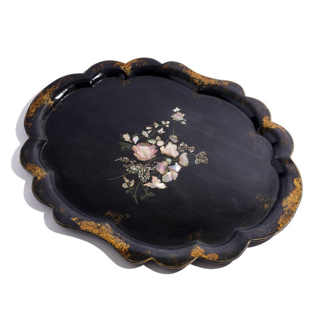 English paper mache tea tray in black with scalloped edge and gilt and bronze powder border in the Rococo taste. The...