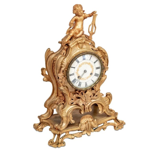 Louis XV Style Gilt Bronze Mantel Clock, late 19th century, the circular dial surmounted by a cherub playing a harp, the...
