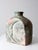 This sculptural vintage cement vase features a striking sun and moon relief that brings depth, movement, and artistic...