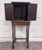 This is a gorgeous antique Tudor Revival walnut silver, jewelry, or collector cabinet circa 1920, featuring figured...