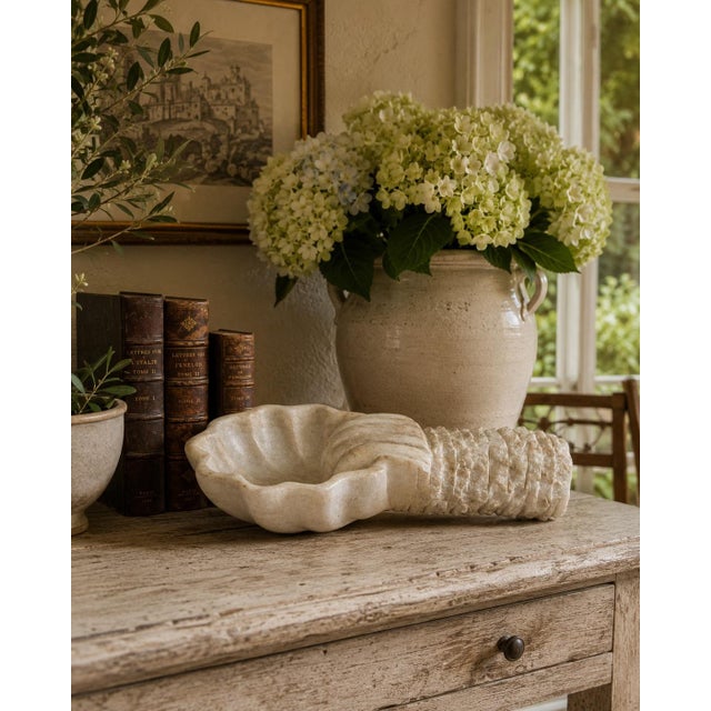 A beautifully weathered late-19th-century Italian holy water font, hand carved from solid marble in the form of an open...
