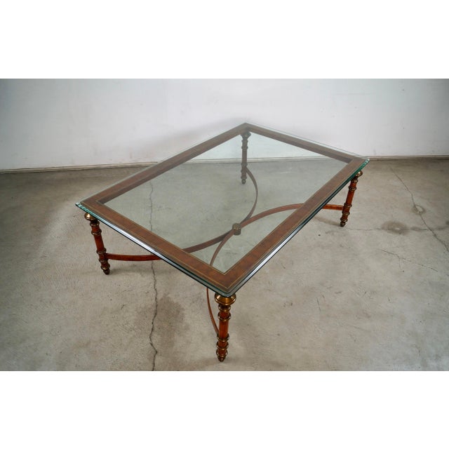 Vintage 1970's Hollywood Regency coffee table for sale. It's made of leather and and gold accents, and has solid brass...