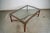 Vintage 1970's Hollywood Regency coffee table for sale. It's made of leather and and gold accents, and has solid brass...