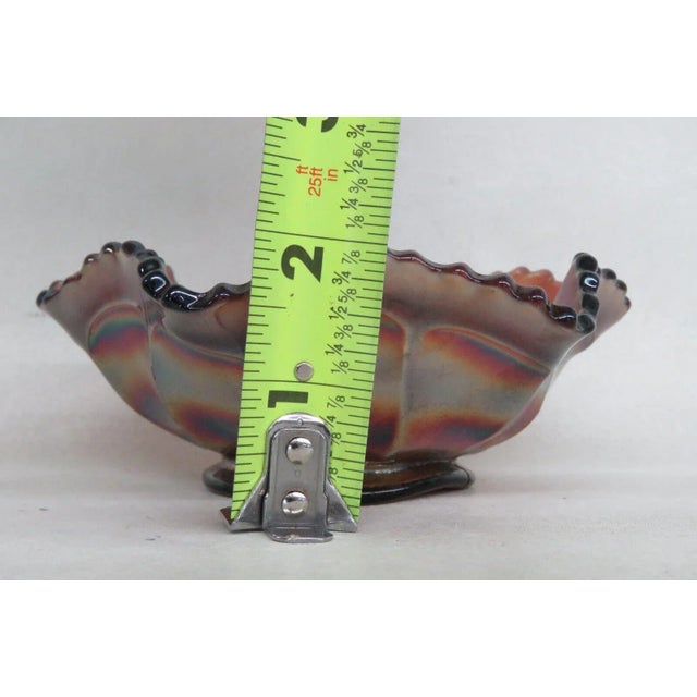 This gorgeous bowl is made of carnival glass. This bowl features a lovely purple color to the glass with a stunning...