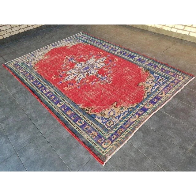 This is a vintage Turkish Oushak rug from the 1960s. The piece was hand-knotted.