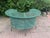 Charming vintage outdoor table featuring a circular green-painted metal mesh top with a distinctive curved cutout, split...