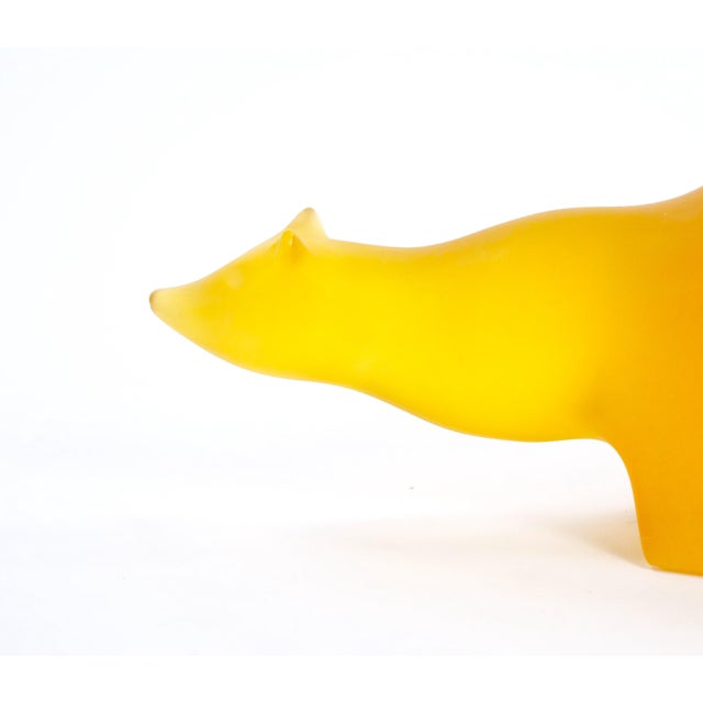 Remarkable mid-20th amber / ice orange composite sculpture showcases a striking polar bear, meticulously crafted with...