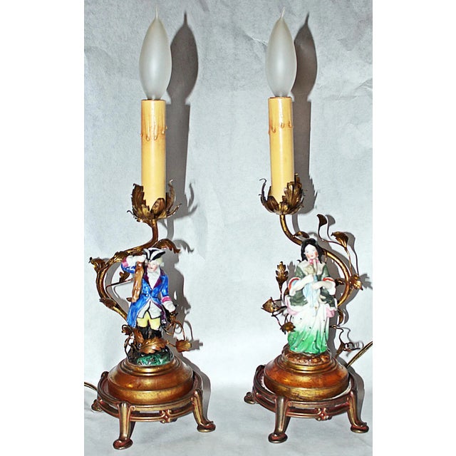 Fab pair of early French hand-decorated porcelain figural tables lamps on dore'-bronze stands and gilt leaf-decorated...