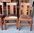Finish is older or original and each chair has a unique natural cowhide upholstered seat featuring varying patterns of...