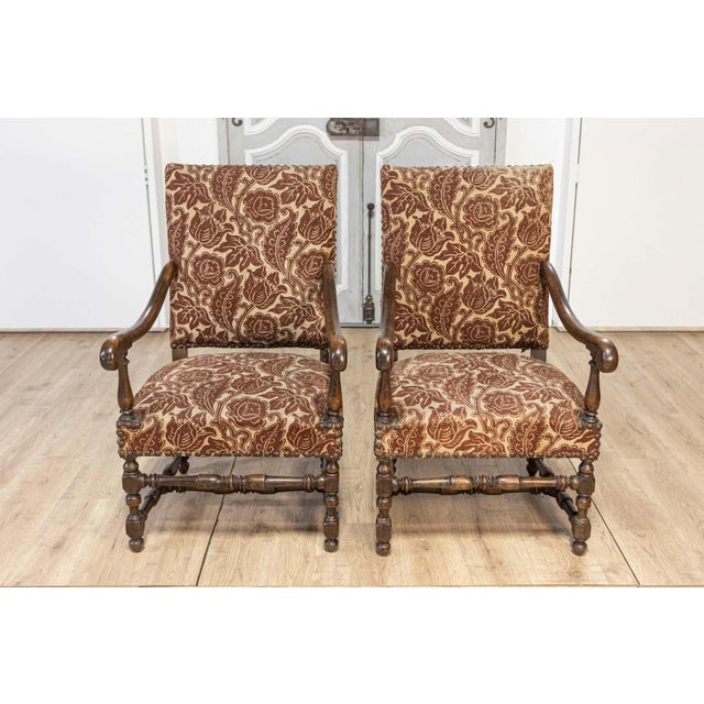 This elegant pair of 20th-century French armchairs exemplifies timeless design and craftsmanship. Constructed from solid...