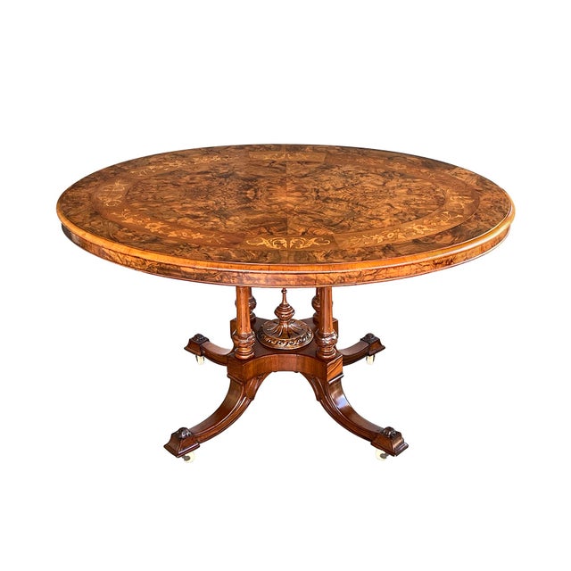 the richly-figured oval top of exquisite quarter veneered burr walnut with inlaid marquetry perimeter band above a burr...