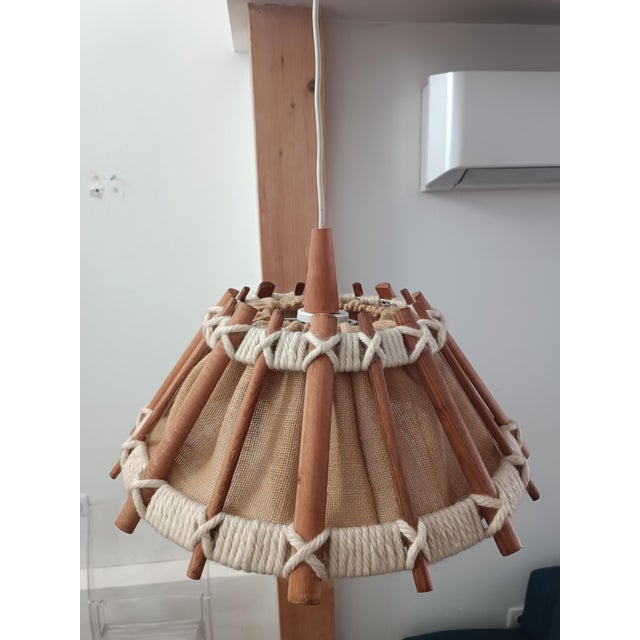 Beautiful Scandinavian pendant lamp. 1970s. Wooden and rope frame. A thick canvas directs the light downwards, its weave...