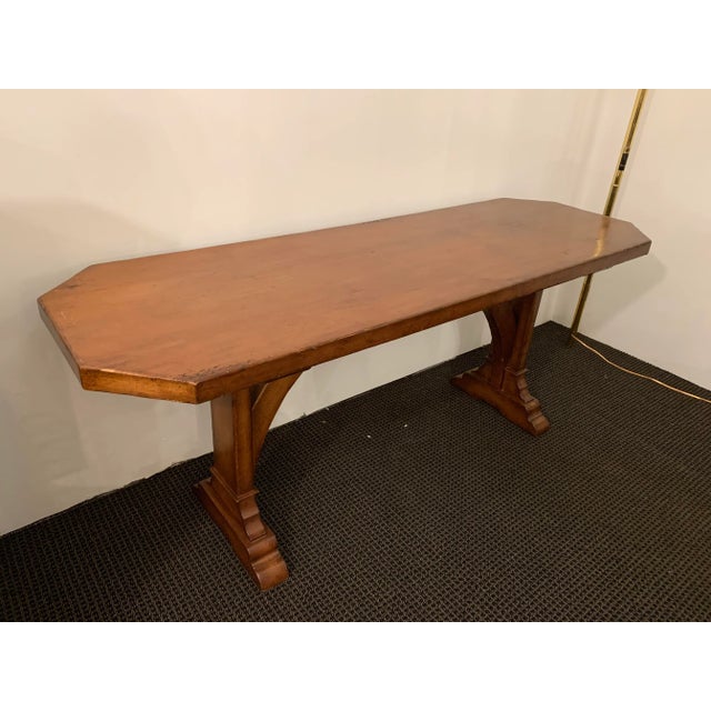 This is very thick wood with lovely detailed legs and arched trestle, topped with a octagonal rectangular shape.
