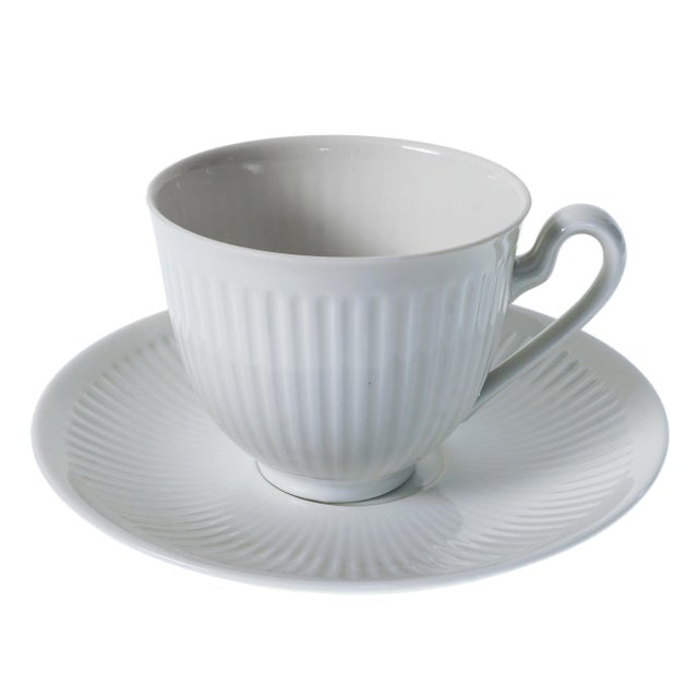 Stylish and timeless Royal Copenhagen 12-piece cup and saucer set in the Georgiana pattern, crafted from fine, all-white...