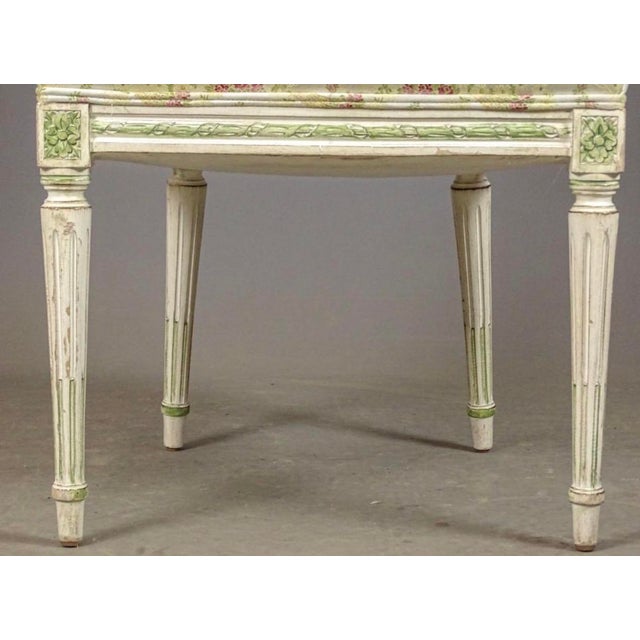 A very decorative sturdy French side or desk chair. With foliate carved ribbons. Painted in off white with pale green...