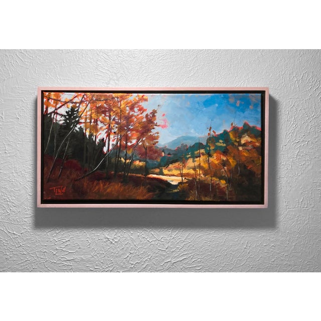 Ralston Fall, 2024 captures the vibrant hues of autumn as fiery oranges and yellows dominate the landscape, contrasting...