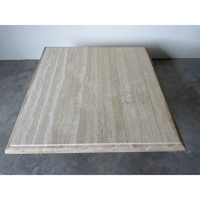 A stunning 1980s Italian Postmodern travertine coffee table by Stone International, showcasing masterful craftsmanship and...